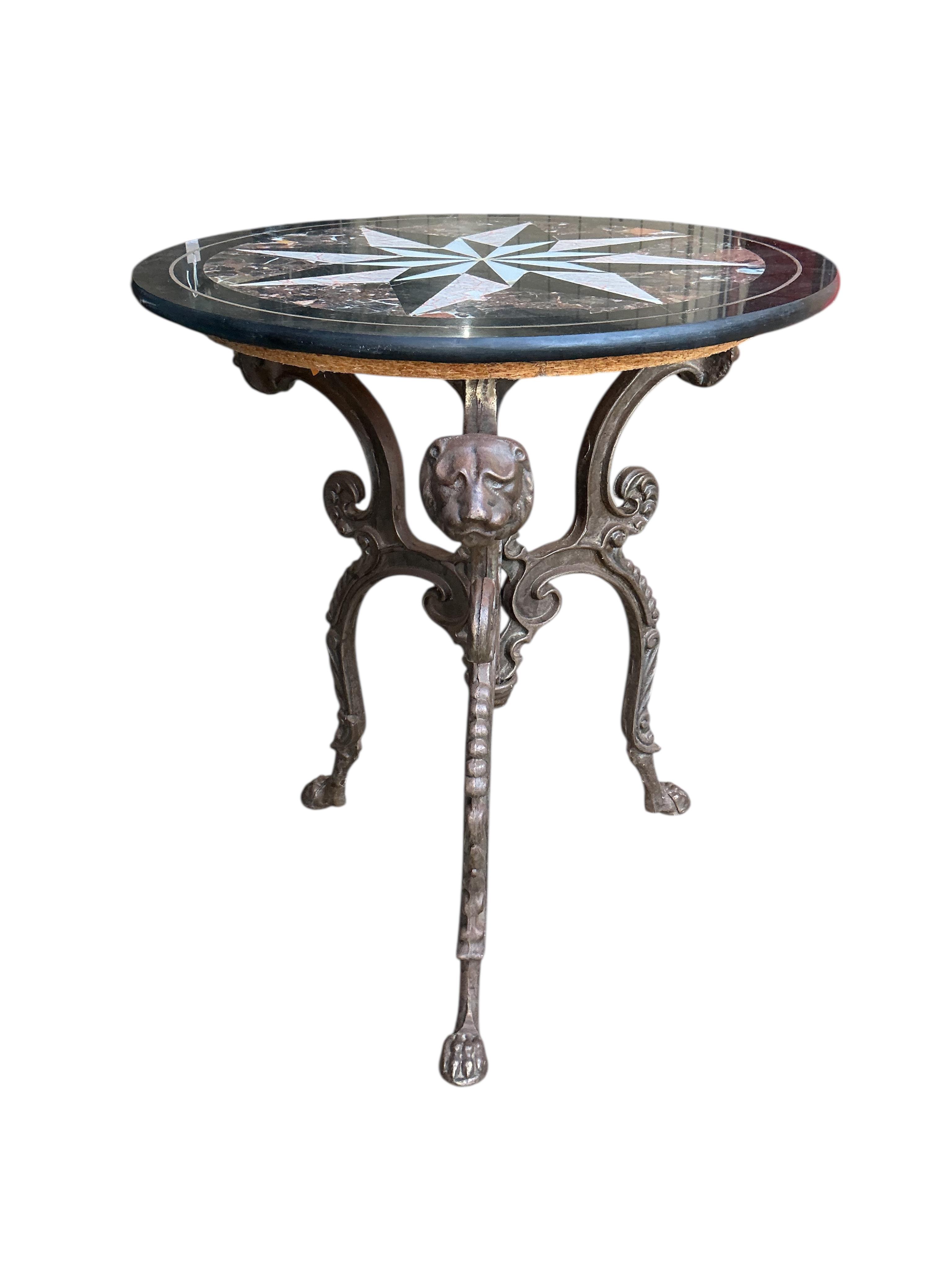 A circular specimen marble top occasional table on cast metal lion mask underframe, diameter 61cm, height 71cm